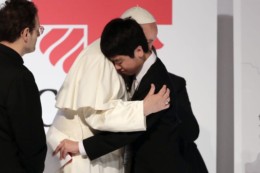 Pope Francis hugs Matsuki Kamoshita as he meets with victims of the March 11, 2011 Fukushima nuclear plant disaster in northern Japan Monday, Nov. 25, 2019, in Tokyo, Japan.