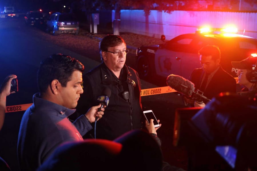 Fresno Police Lt. Bill Dooley speaks to reporters at the scene of a shooting at a backyard party Sunday, Nov. 17, 2019, in southeast Fresno, Calif. Multiple people were shot and at least four of them were killed Sunday at a party in Fresno when suspects sneaked into the backyard and fired into the crowd, police said.