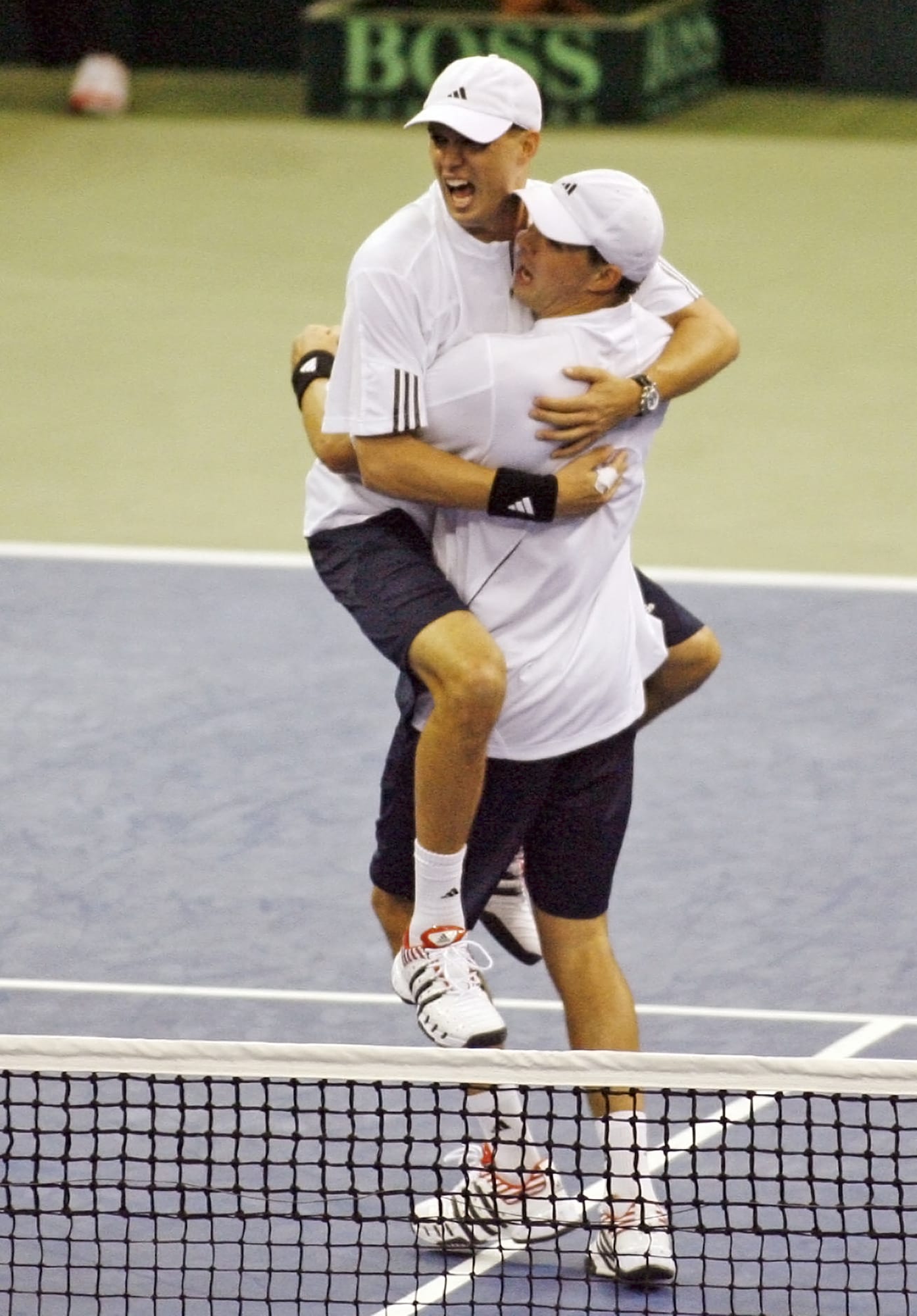 United States' Mike Bryan, left, jumps into his brother Bob Bryan's arms after defeating Russia's Igor Andreev and Nikolay Davydenko 7-6 (4), 6-4, 6-2 in the title-clinching Davis Cup Final doubles match on Saturday, Dec. 1, 2007 in Portland. The twins announced on Wednesday, Nov. 13, 2019 that they will retire after playing in the 2020 U.S. Open.