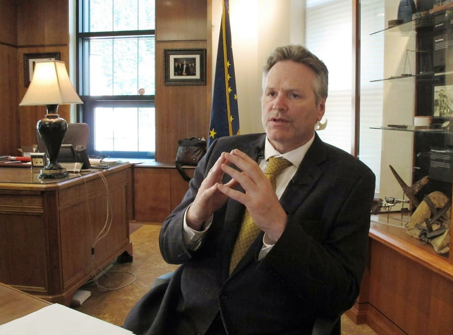 FILE - In this May 29, 2019 file photo, Alaska Gov. Mike Dunleavy speaks to reporters in his office at the state Capitol in Juneau, Alaska. Dunleavy said he hopes to move past the rancor of his first year in office, amid an unsettled dispute with lawmakers over state spending and threat of a recall effort looming large. The Republican will mark a full year in office Tuesday, Dec. 3.