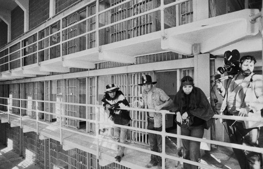 FILE - In this Nov. 19, 1969, file photo, part of a band of Native Americans look over the main cell block of Alcatraz after occupying the island in San Francisco. The week of Nov. 18, 2019, marks 50 years since the beginning of a months-long Native American occupation at Alcatraz Island in the San Francisco Bay. The demonstration by dozens of tribal members had lasting effects for tribes, raising awareness of life on and off reservations, galvanizing activists and spurring a shift in federal policy toward self-determination.
