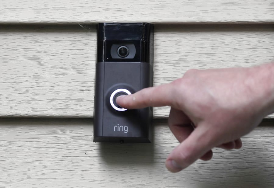 FILE - In this July 16, 2019, file photo, Ernie Field pushes the doorbell on his Ring doorbell camera at his home in Wolcott, Conn. Amazon says it has considered adding facial recognition technology to its Ring doorbell cameras. The company said in a letter released Tuesday, Nov. 19 by U.S. Sen. Ed Markey that facial recognition is a &quot;contemplated, but unreleased feature&quot; of its home security cameras. The Massachusetts Democrat wrote to Amazon CEO Jeff Bezos in September raising privacy and civil liberty concerns about Ring&#039;s video-sharing partnerships with hundreds of police departments around the country.