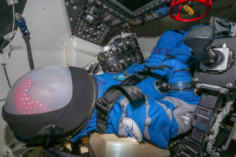 This photo provided by Boeing shows Rosie the astronaut test dummy positioned in the space capsule at Kennedy Space Center.