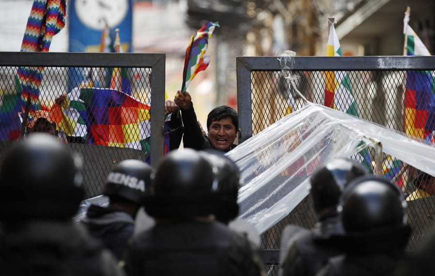Police block supporters of former President Evo Morales from entering the area of Congress in La Paz, Bolivia, Tuesday, Nov. 12, 2019. Morales, who transformed Bolivia as its first indigenous president, flew to exile in Mexico on Tuesday after weeks of violent protests, leaving behind a confused power vacuum in the Andean nation.