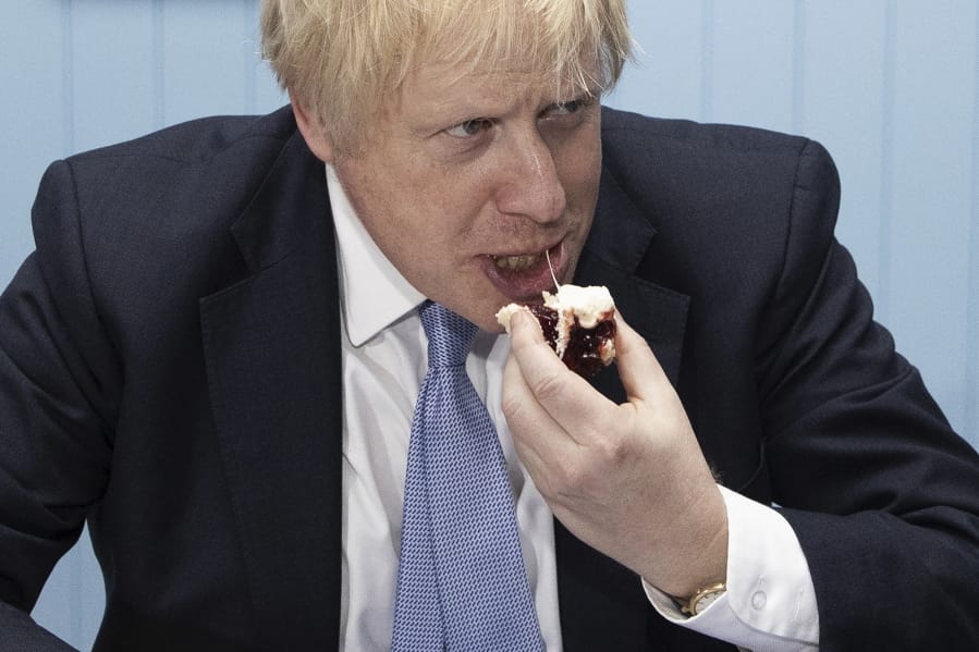 Britain&#039;s Prime Minister Boris Johnson enjoys a cream tea during a photocall while touring &#039;Rodda&#039;s Clotted Cream&#039;, in Redruth, England, Wednesday, Nov. 27, 2019. Britain goes to the polls on Dec. 12.
