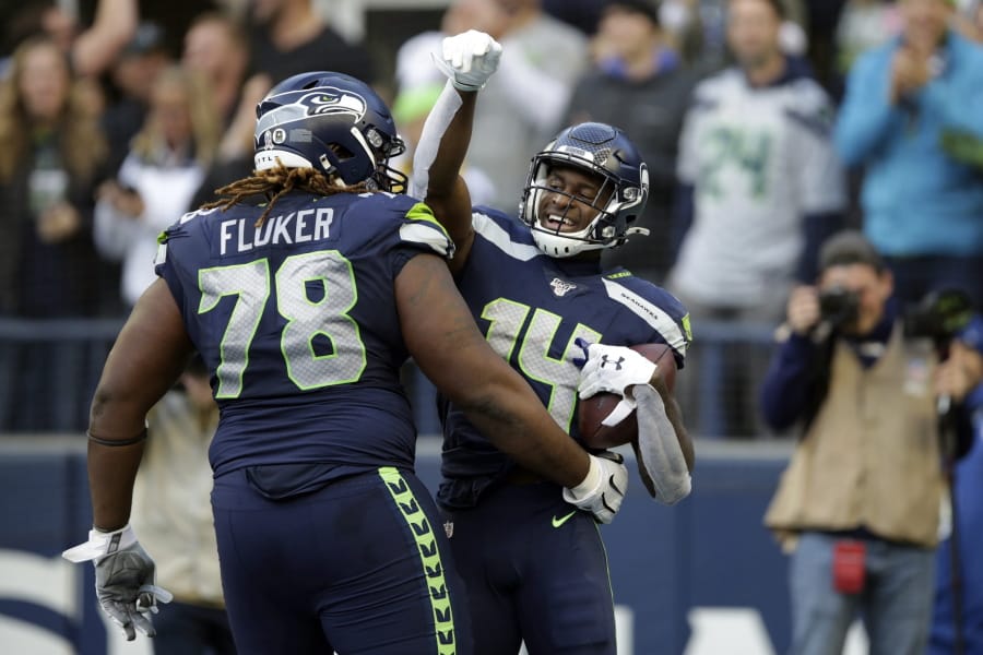 Seattle Seahawks wide receiver DK Metcalf, right, celebrates with D.J. Fluker (78) after scoring a touchdown against the Tampa Bay Buccaneers during the second half of an NFL football game, Sunday, Nov. 3, 2019, in Seattle.
