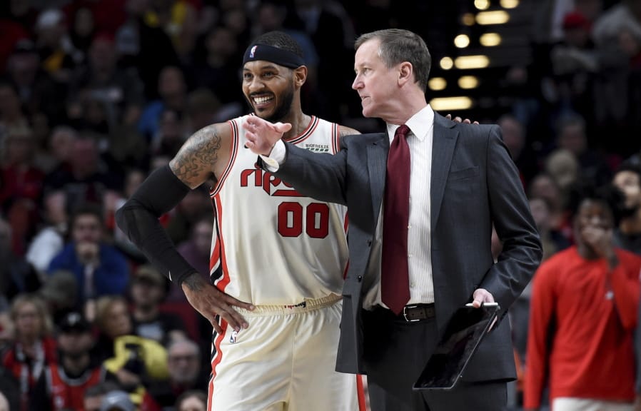 Portland Trail Blazers forward Carmelo Anthony, left, speaks with head coach Terry Stotts during the second half of an NBA basketball game against the Chicago Bulls in Portland, Ore., Friday, Nov. 29, 2019. The Blazers won 107-103.