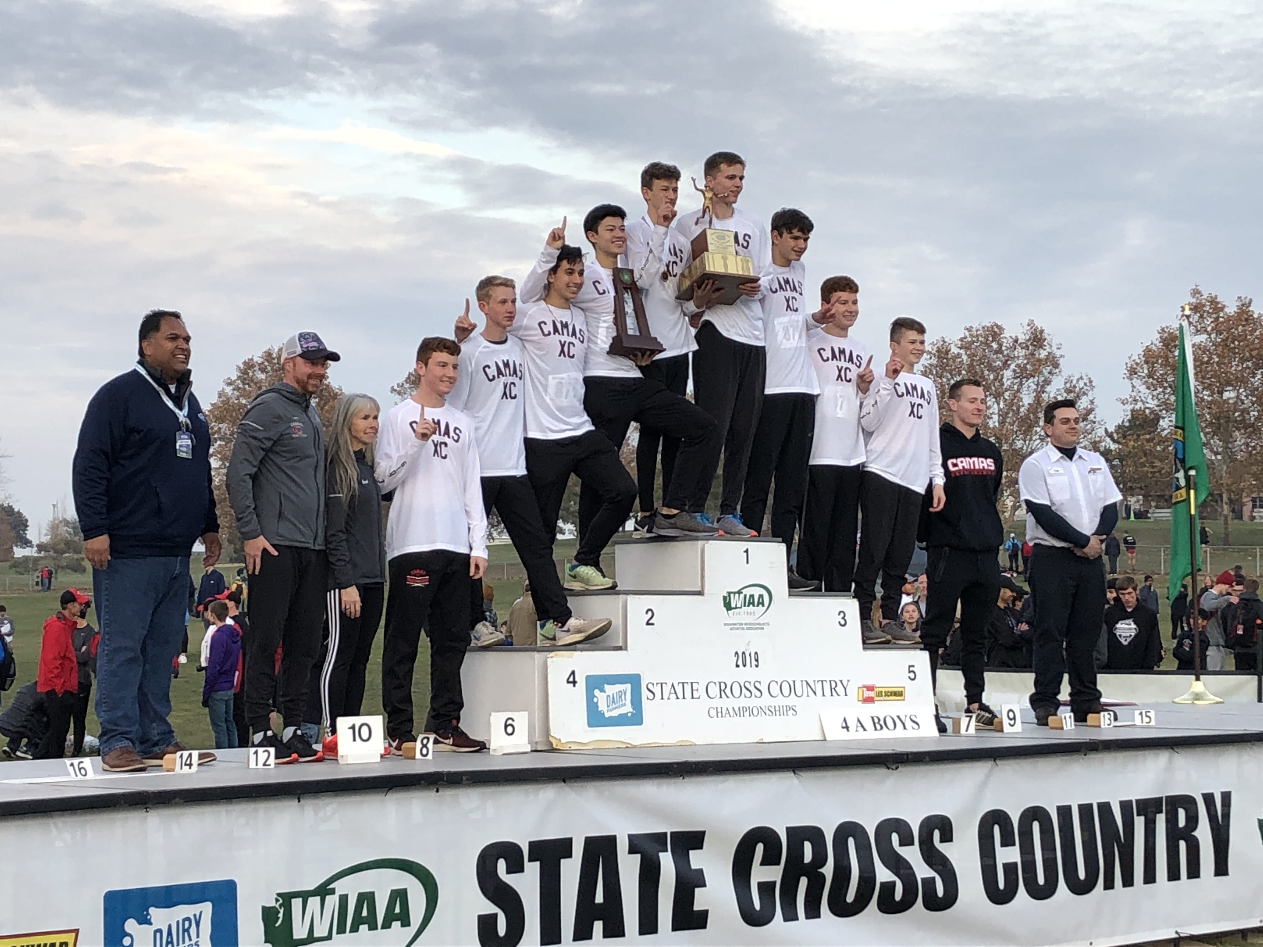 The Camas boys cross country team celebrates with the Class 4A state championship trophy at the state championships on Saturday in Pasco.