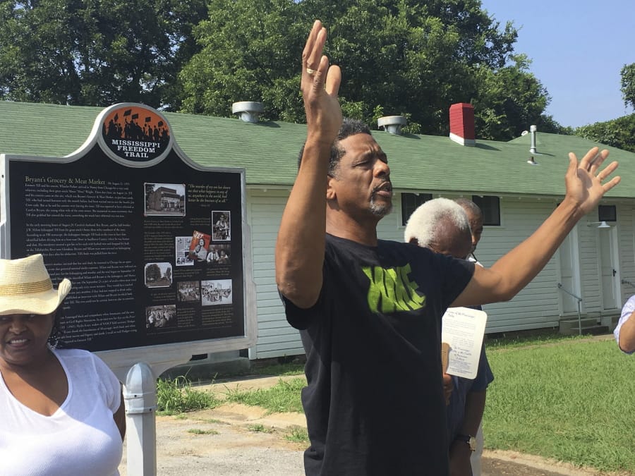FILE - In this July 25, 2017 file photo, Rev. Willie Williams of Raleigh United Methodist Church in Sumner, Miss., prays during the rededication of the Emmett Till marker on the Mississippi Freedom Trail at Money, Miss. Memorials to Holocaust victims and others dedicated to people of color across the U.S. repeatedly are vandalized, forcing volunteers, cities and universities to spend hundreds of thousands on repairs and security.