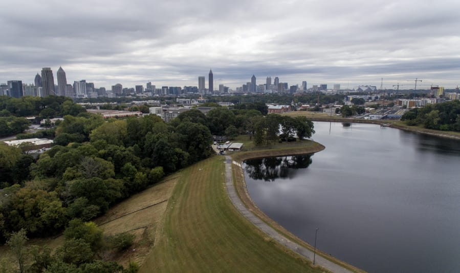 Reservoir No. 1, a 180 million-gallon water supply that has been out of service much of the past few decades, sits against the backdrop of the city skyline, Oct. 15, 2019, in Atlanta. The city made repairs and brought it back online in 2017, only to shut it down again after water leaks were noticed near businesses located beneath the dam. Were the dam to catastrophically fail, the water could inundate more than 1,000 single-family homes, dozens of businesses, a railroad and a portion of Interstate 75, according to an emergency action plan.