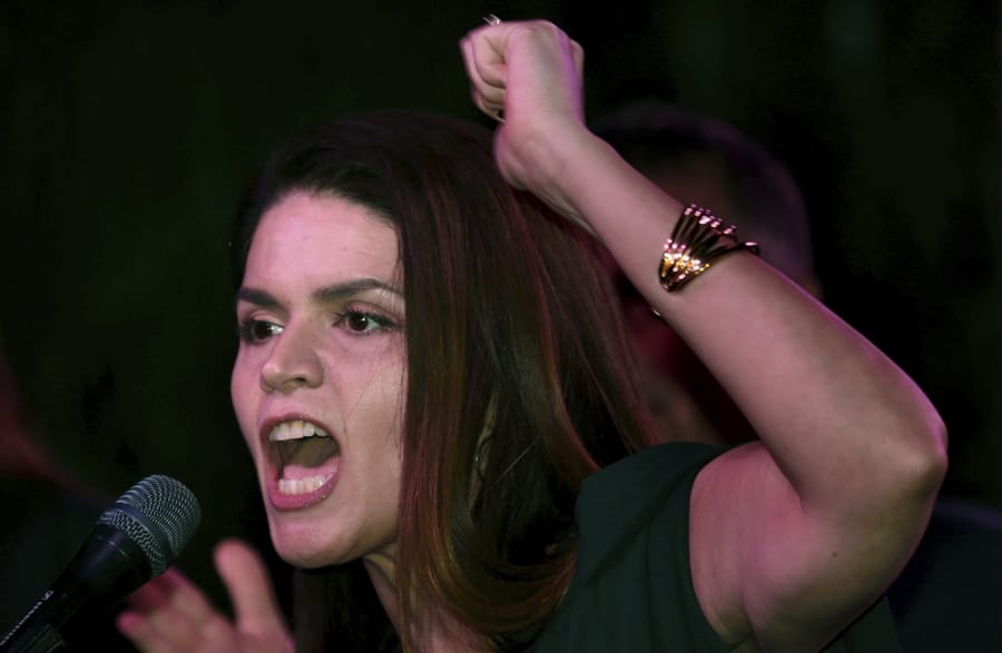 Mayor-elect Regina Romero leads the crowd of well-wishers in a &quot;Is se puede&quot; chant following the announcement of her win during an election night party at Hotel Congress, Tucson, Ariz., Nov. 5, 2019. Romero, the daughter of farmworkers, is the city&#039;s first Latina mayor in the city&#039;s history.