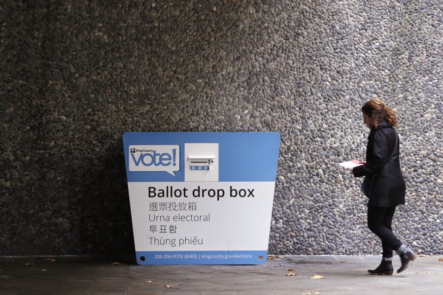 A voter heads to a ballot drop box Monday, Nov. 4, 2019, in Seattle. Voters in Washington state have a crowded ballot to fill out for this week&#039;s election, with a referendum on affirmative action and an initiative on the price of car tabs among the things they are being asked to decide.