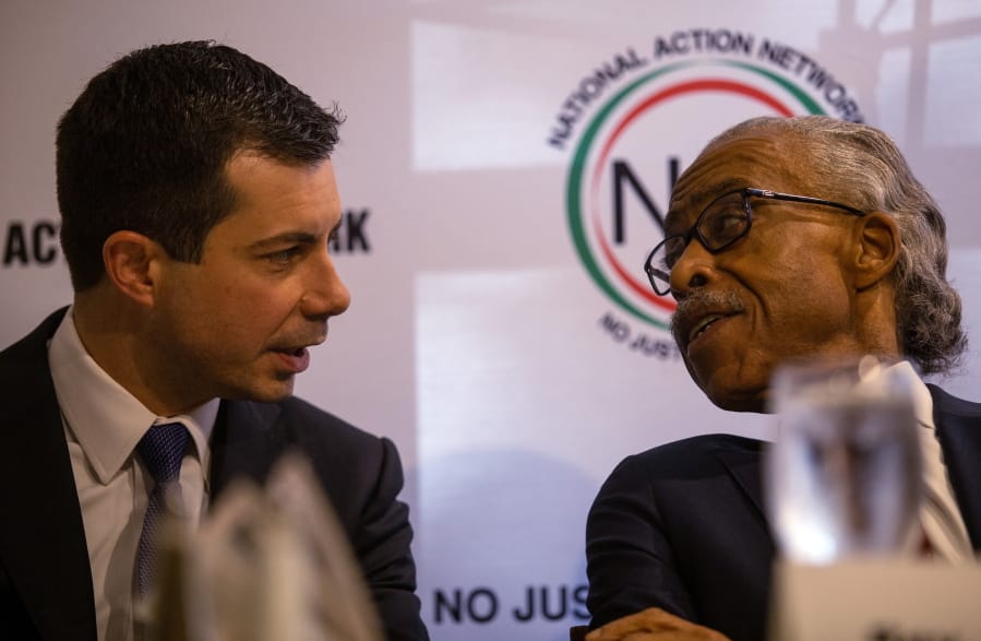 Pete Buttigieg, left, speaks with the Rev. Al Sharpton at a breakfast event on Thursday, November 21, 2019, in Atlanta. Buttigieg, along with Cory Booker, Amy Klobuchar, Andrew Yang and Tom Steyer, all presidential hopefuls, spoke at the event hosted by the Sharpton&#039;s National Action Network.