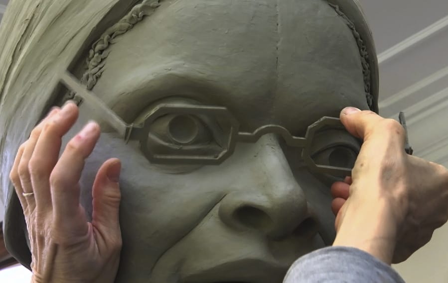 In this Nov. 4, 2019, still image from video, sculptor Meredith Bergmann works on the first women&#039;s statue that will be installed in New York&#039;s Central Park, in her studio in Ridgefield, Conn. The monument is scheduled to be dedicated Aug. 26, 2020, marking the 100th anniversary of American women winning the right to vote.
