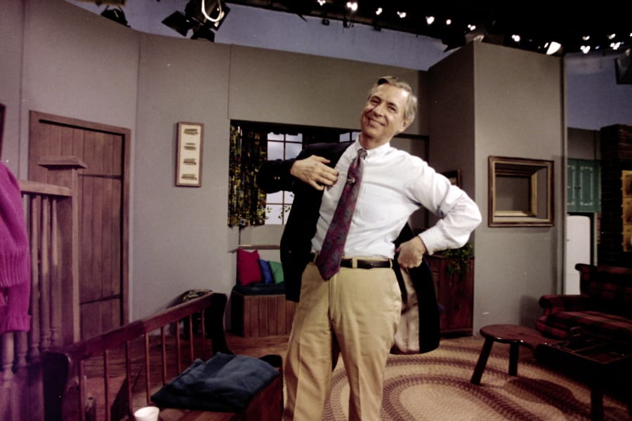 Fred Rogers puts on his jacket between takes on the set of his television program &quot;Mister Rogers&#039; Neighborhood&quot; in Pittsburgh on June 8, 1993. (Gene J.
