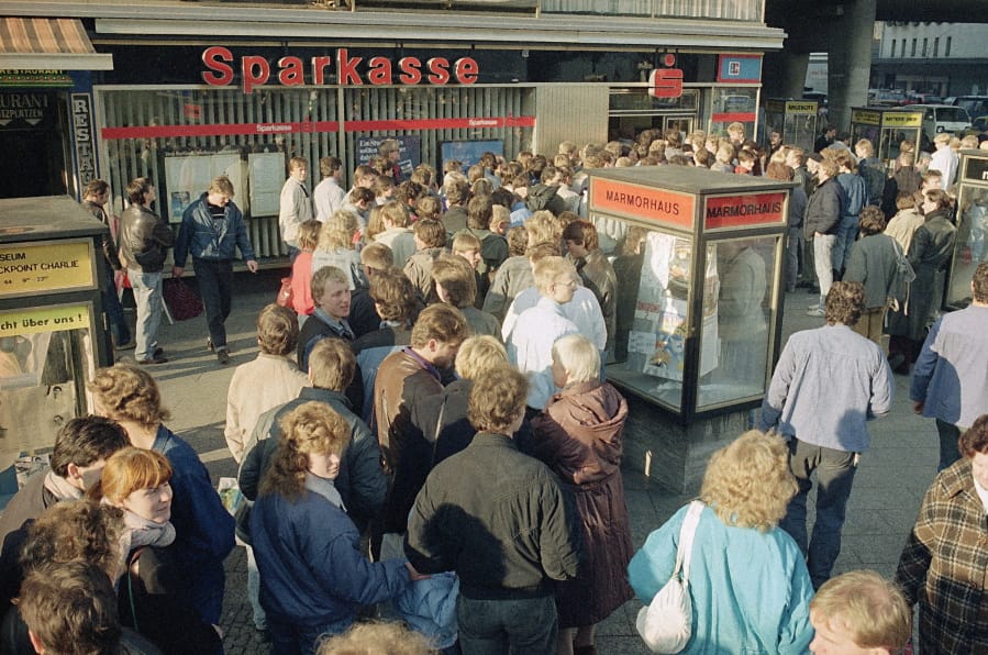 FILE - In this Nov. 10, 1989, file photo East Berliners queue outside a West Berlin bank to receive the 100-Deutsche-Mark &quot;welcome money&quot; the West German government gives all East Germans as financial help. The abrupt fall of the Wall in 1989 and lightning speed that reunification took place took everyone by surprise at the time and was a shock to the system for some 16 million East Germans. Unrealistic expectations combined with other factors have helped lead to today&#039;s discontent, providing fertile ground for the far-right.