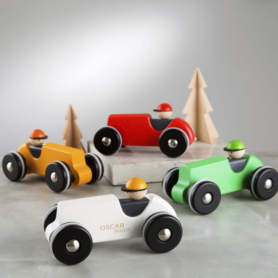 Wooden racing cars that can be engraved with a child&#039;s name and a special date from Etsy seller TwentySevenUK. The seller offers free shipping to the U.S. Each car is $43.05 and comes in white, yellow or green.