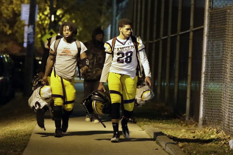 Camden High School football players walk down Park Blvd. in Camden, N.J., as they head back to their football field and locker room on Friday night, November 15, 2019. Earlier in the evening, Camden&#039;s football game at Pleasantville H.S.