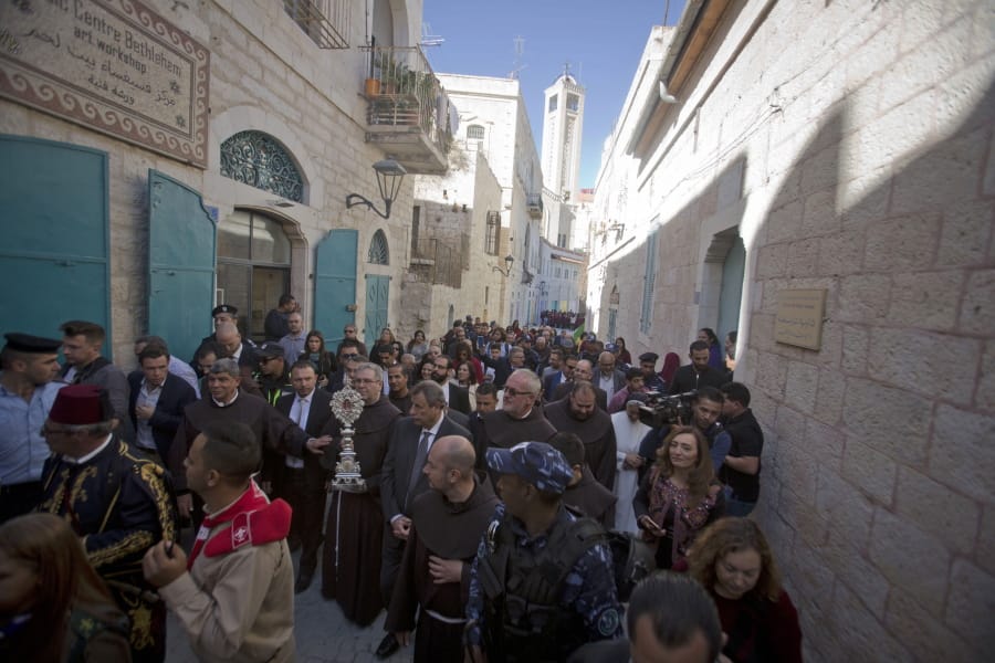 Christian clergymen, carry a wooden relic believed to be from Jesus&#039; manger outside the Church of the Nativity, traditionally believed by Christians to be the birthplace of Jesus Christ in the West Bank city of Bethlehem, Saturday, Nov. 30, 2019. A tiny wooden relic believed to have been part of Jesus&#039; manger has returned to its permanent home in the biblical city of Bethlehem 1,400 years after it was sent to Rome as a gift to the pope.