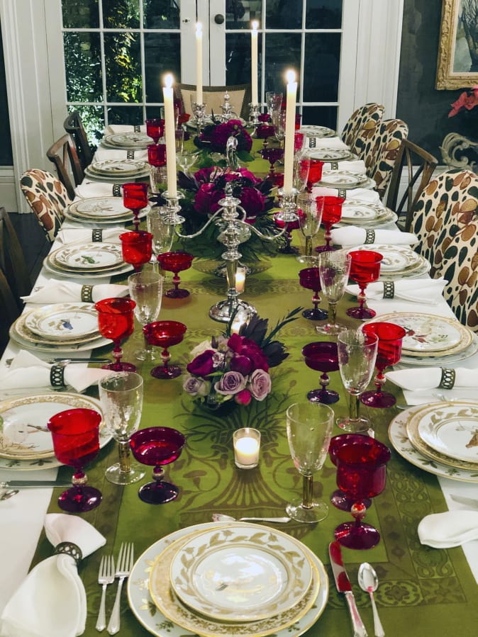 A table setting design by interior designer Elizabeth Stuart in a residence in Charleston, S.C. When setting a beautiful holiday table, consider using several small, low centerpieces rather than one large one.