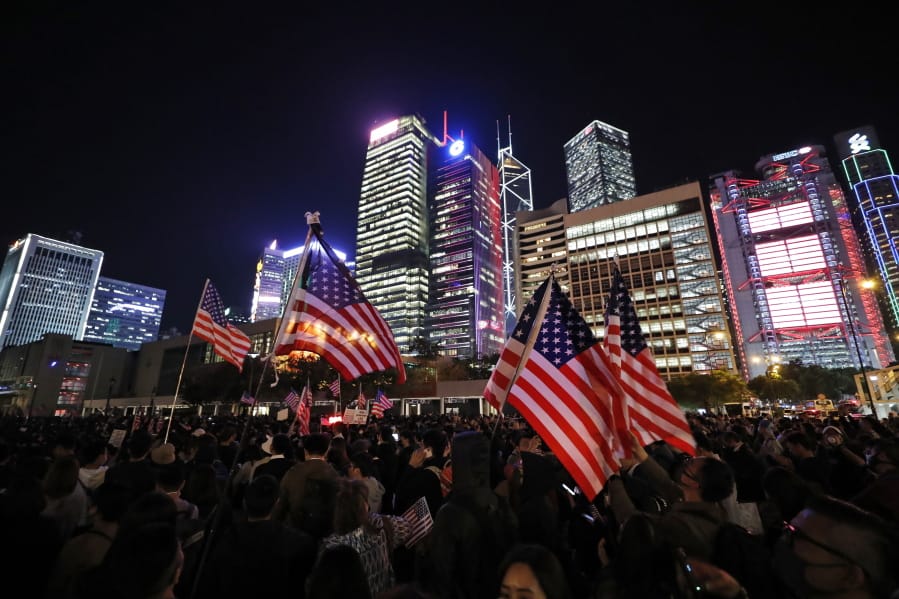 Protester holds U.S. flags during a demonstration in Hong Kong, Thursday, Nov. 28, 2019. China&#039;s fury over President Donald Trump&#039;s decision to sign legislation supporting human rights in Hong Kong is evident. What&#039;s less clear what &quot;countermeasures&quot; Beijing may take in response to what it said Thursday were &quot;extremely evil&quot; and dangerous moves.