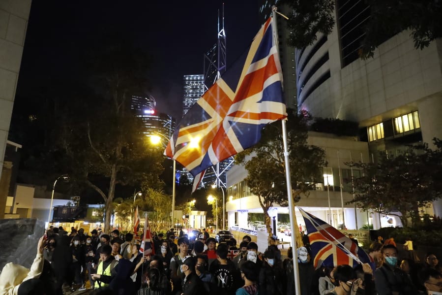 Protesters wave a British flag as they gather for a rally outside of the British Consulate in Hong Kong, Friday, Nov. 29, 2019. Hong Kong police ended their blockade of a university campus Friday after surrounding it for 12 days to try to arrest anti-government protesters holed up inside.