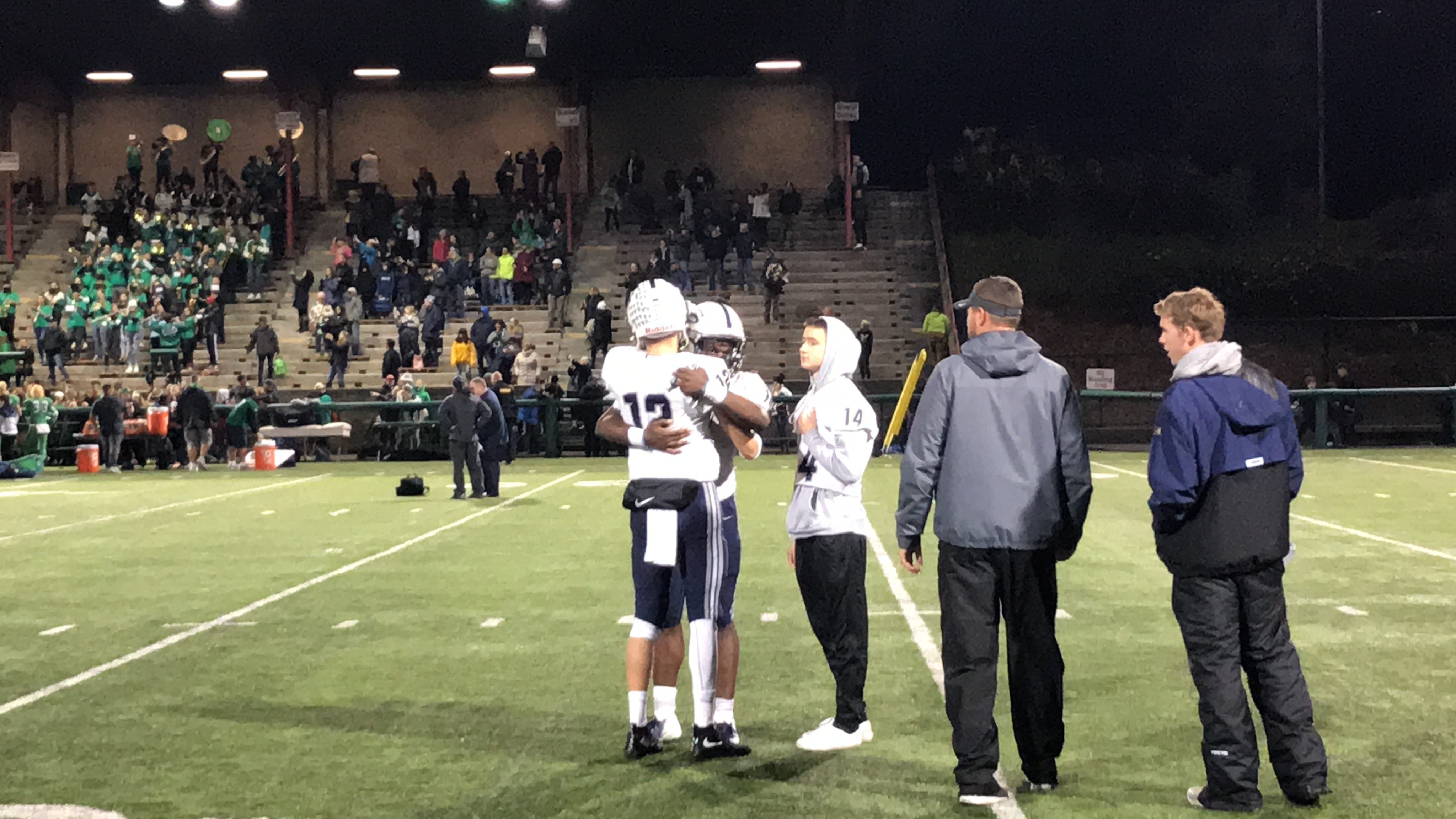 Skyview's Yaro Duvalko (12) and Jalynnee McGee embrace after Saturday's 38-17 loss to Woodinville in the teams' 4A first-round state playoff game in Bothell.