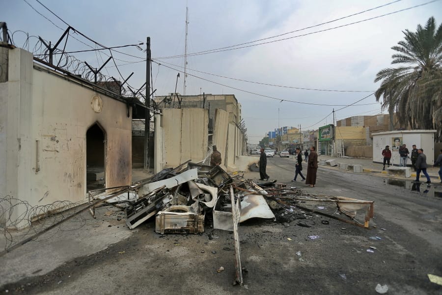 Security forces and civilians gather near the burned Iranian consulate in Najaf, Iraq, Thursday, Nov. 28, 2019. An Iraqi police official says anti-government protesters have burned down the Iranian consulate in southern Iraq late Wednesday. Protesters torched the Iranian consulate building in the holy city of Najaf, the seat of the country&#039;s Shiite religious authority. Iranian staff working in the consulate escaped through the back door and were not harmed.