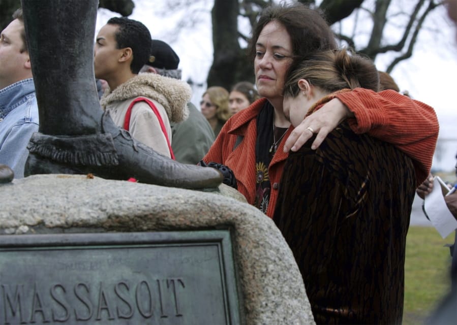 FILE - In this Nov. 25, 2004 file photo, Native American supporter Deborah Theodore, left, of Belmont, Mass., and her daughter, Sofia Theodore-Pierce stand together by the statue of Massasoit on Cole&#039;s Hill in Plymouth, Mass., during the 35th National Day of Mourning. United American Indians of New England held the first National Day of Mourning in 1970, and again plan to gather at noon on Thanksgiving Day, Thursday, Nov. 28, 2019.