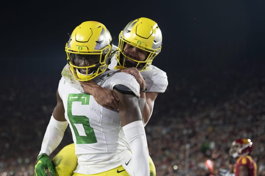 Oregon wide receiver Juwan Johnson, left, celebrates his touchdown with running back Travis Dye during the second half of an NCAA college football game against Southern California, Saturday, Nov. 2, 2019, in Los Angeles.