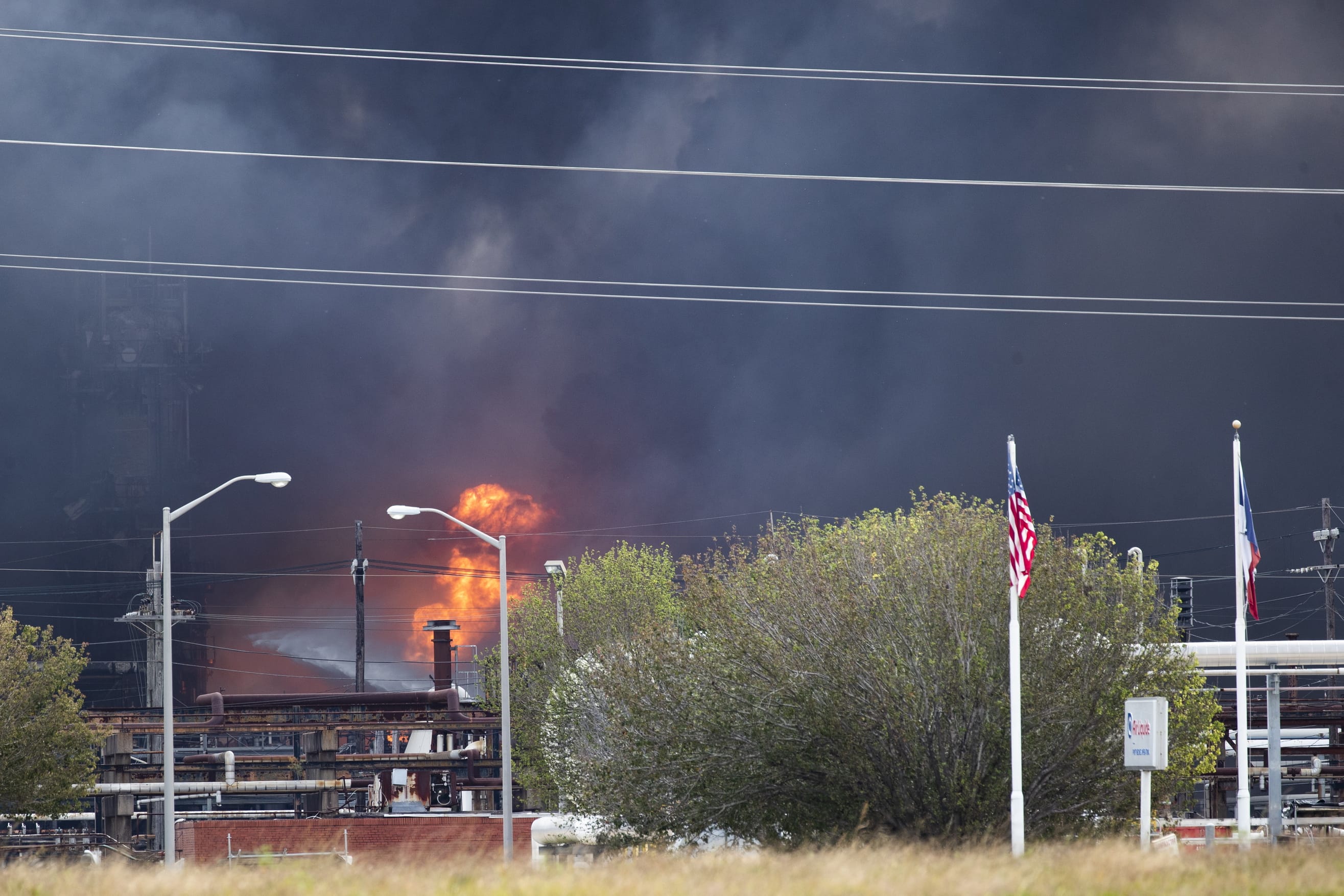 Smoke and fire are visible from the TPC Group Port Neches Operations explosion on Wednesday, Nov. 27, 2019, in Port Neches, Texas.  Three workers were injured early Wednesday in a massive explosion at the Texas chemical plant that also blew out the windows and doors of nearby homes.  (Marie D.