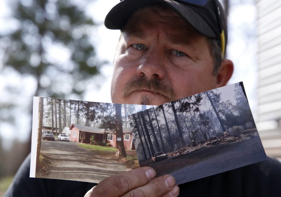 In this Thursday Oct. 24, 2019, photo, Bill Husa displays before-and-after photos of his home lost in last year&#039;s Camp Fire in Paradise, Calif. Husa&#039;s home is one of nearly 9,000 Paradise homes destroyed in the deadliest and most destructive wildfire in California history.