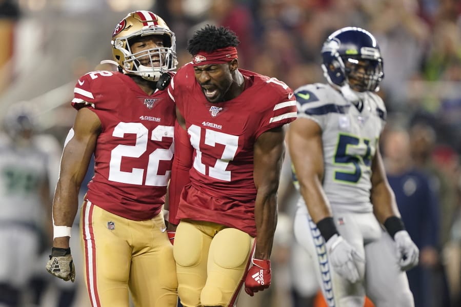 San Francisco 49ers wide receiver Emmanuel Sanders (17) yells next to running back Matt Breida (22) and Seattle Seahawks middle linebacker Bobby Wagner (54) during the first half of an NFL football game in Santa Clara, Calif., Monday, Nov. 11, 2019.