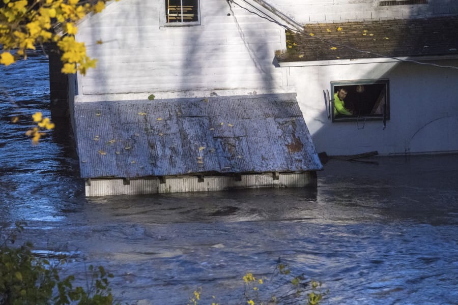 In this photo provided by the New York State Governor&#039;s Office, a man looks from a window of a house being flooded by rising waters of the East Canada Creek, Friday, Nov. 1, 2019 in Dolgeville, N.Y. He was rescued by local police. Several hundred people were being evacuated in scattered areas around the state because of high waters.
