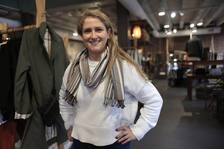 In this Thursday, Nov. 14, 2019, photo, Annie Venditti, vice president of operations at clothing retailer American Rhino, stands for a photograph in the store, in Faneuil Hall Marketplace, in Boston. At the age of 23, Venditti was learning about the complexities of building and liquor laws. The company did the smart thing, and got a consultant to guide them.