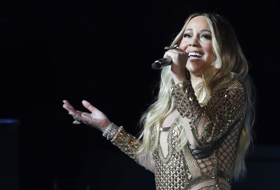 FILE - This Oct. 20, 2019 file photo shows Mariah Carey performing during a concert celebrating Dubai Expo 2020 One Year to Go in Dubai, United Arab Emirates.  The Neptunes, the innovative production-songwriting duo of Pharrell Williams and Chad Hugo, are nominated for the prestigious Songwriters Hall of Fame 2020 class. Joining them as nominees are Outkast, R.E.M., Mariah Carey, Patti Smith, Journey, Vince Gill, Gloria Estefan, the Isley Brothers, the Eurythmics, Mike Love, David Gates and Steve Miller.