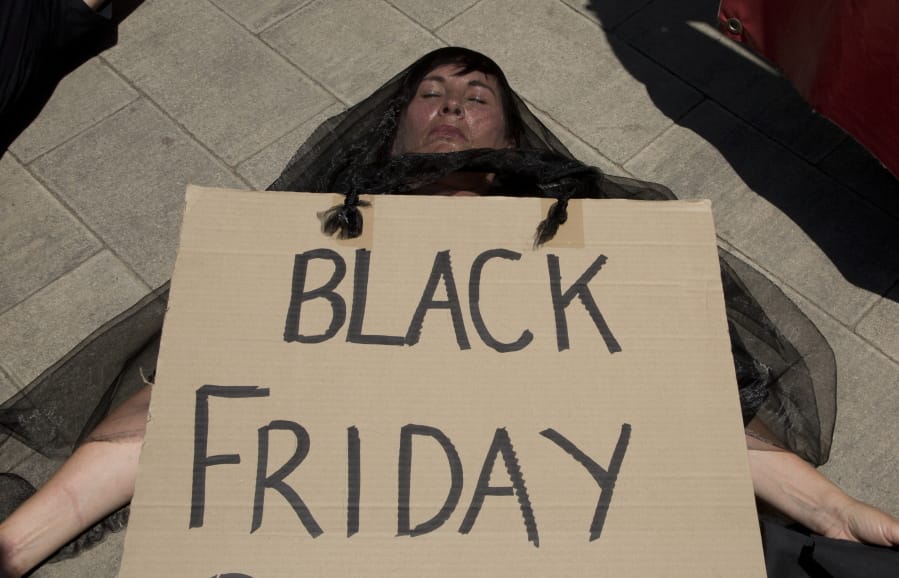 A demonstrator &quot;plays dead&quot; during climate change protest outside the Johannesburg Stock Exchange in Johannesburg Friday, Nov. 29, 2019. Environmentalists around the world are joining a global day of protests Friday, in a symbolic gesture to demand that all governments act against climate change.