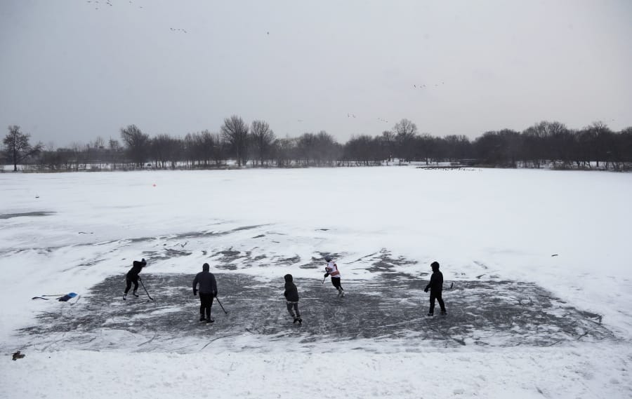 FILE - In this Thursday, Jan. 4, 2018 file photo, youths play ice hockey on a frozen pond at Philadelphia&#039;s Franklin Delano Roosevelt Park during a winter storm. New concussion guidance shows there isn&#039;t enough solid evidence to answer some of parents&#039; most burning questions about contact sports. That includes what age is safest to start playing them.