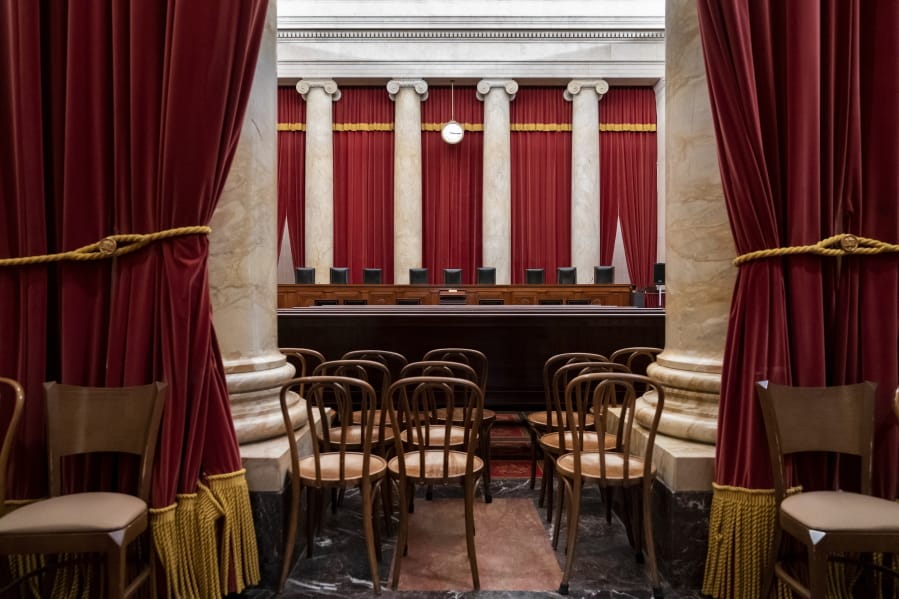 FILE - In this June 24, 2019, file photo, the empty courtroom is seen at the U.S. Supreme Court in Washington. The lack of transparency at the Supreme Court begins with the heavy red drapes that frame the courtroom on all sides. The court replaced the drapes this summer, but it would not reveal the name of the company that did the work. The Supreme Court&#039;s role in a bitterly divided Washington and nation may be more important than ever, yet basic details about how the court operates remain obscured. (AP Photo/J.