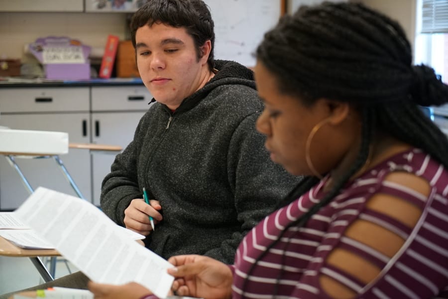 Joseph Tucker watches as Makizah Cotton makes an argument in civics class at Chatham Central High School in Bear Creek, N.C., on Tuesday, Nov. 5, 2019. The 10th-graders were debating whether President Trump should be impeached. (AP Photo/Allen G.