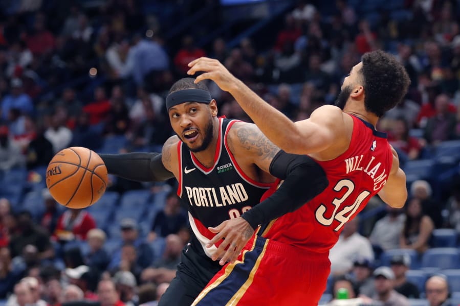 Portland Trail Blazers forward Carmelo Anthony is defended by New Orleans Pelicans guard Kenrich Williams (34) during the second half of an NBA basketball game in New Orleans, Tuesday, Nov. 19, 2019. The Pelicans won 115-104.