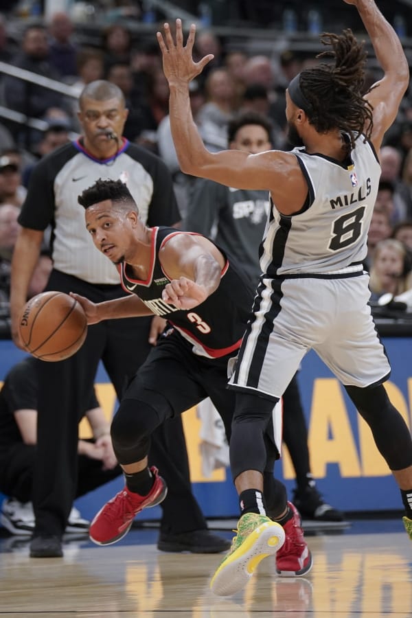 Portland Trail Blazers&#039; C.J. McCollum (3) is called for an offensive foul after colliding with San Antonio Spurs&#039; Patty Mills during the first half of an NBA basketball game, Saturday, Nov. 16, 2019, in San Antonio.