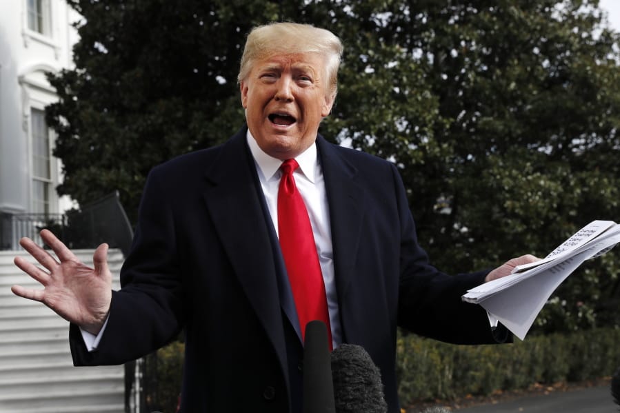 President Donald Trump holds handwritten notes as he speaks to the media about the House Intelligence Committee testimony of U.S. Ambassador to the European Union Gordon Sondland, Wednesday, Nov. 20, 2019, as Trump leaves the White House in Washington, en route to Texas.