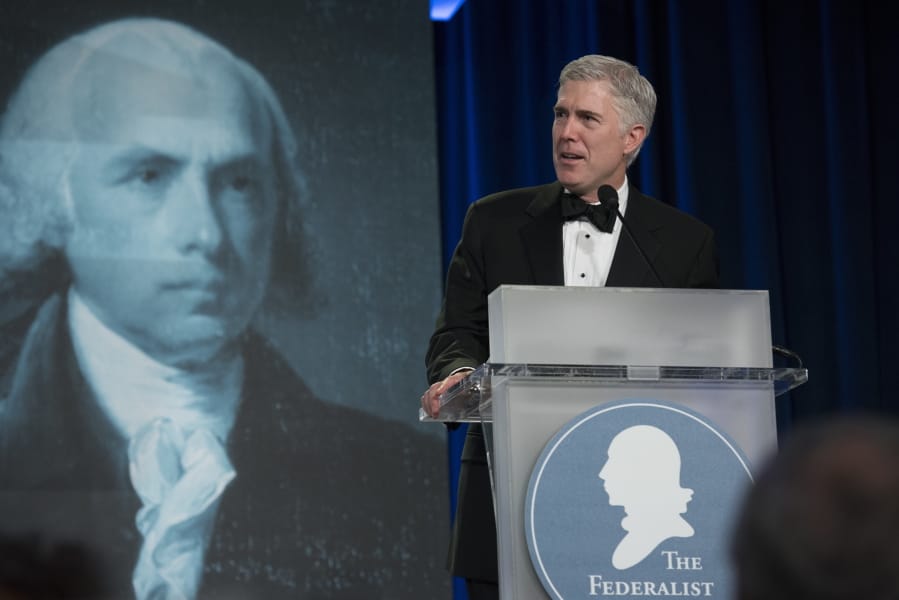 FILE - In this Nov. 16, 2017, file photo, Supreme Court Associate Justice Neil Gorsuch speaks at the Federalist Society&#039;s 2017 National Lawyers Convention in Washington. A liberal activist group is launching a digital ad campaign targeting the Federalist Society, a conservative legal organization that has championed judges appointed by President Donald Trump, including Supreme Court Justices Brett Kavanaugh and Gorsuch. The ads, to appear on LinkedIn and Facebook, target major law firms that were sponsored the Federalist Society&#039;s annual dinner.