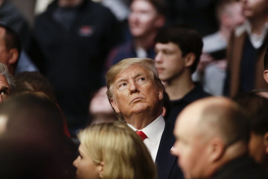 President Donald Trump watches a replay of a lightweight mixed martial arts bout between Kevin Lee and Gregor Gillespie at UFC 244, Saturday, Nov. 2, 2019, in New York. Lee stopped Gillespie in the first round.