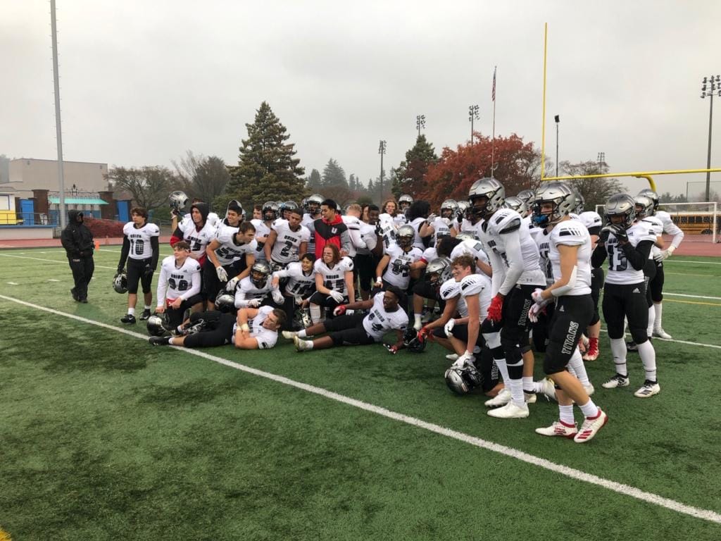 Union players pose for photos following a 42-6 win over Mount Rainier in a 4A district crossover game on Saturday at Highline Memorial Stadium in Burien.