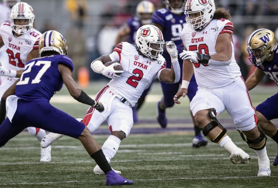 Utah running back Zack Moss (2) runs with the ball during the first half of an NCAA college football game against Washington, Saturday, Nov. 2, 2019, in Seattle.