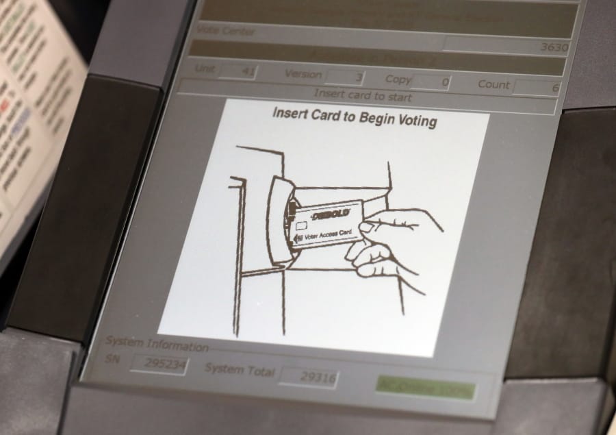 FILE - This May 9, 2018, photo shows a touch screen of a voting machine during early voting in Sandy Springs, Ga. New voting machines that combine touchscreens with paper ballots are getting a limited test run in Georgia. It&#039;s part of an effort to meet a court-ordered deadline to retire the old touchscreen only system before any votes are cast in 2020.