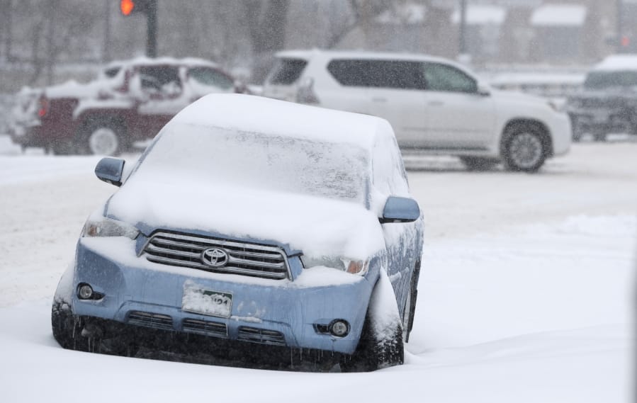 A Toyota Highlander sits abandoned after being damaged near the intersection of 6th Avenue and Speer Boulevard as a storm packing snow and high winds sweeps in over the region Tuesday, Nov. 26, 2019, in Denver. Stores, schools and government offices were closed or curtailed their hours while on another front, Thanksgiving Day travellers were forced to wrestle with snow-packed roads and flight delays or cancellations throughout the intermountain West.