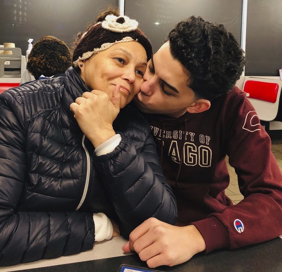 This photo provided by Cristian Padilla Romero, Tania Romero, left, is kissed by her son, Cristian Padilla Romero, in an Atlanta restaurant in 2019. The Yale University graduate student is trying to prevent the deportation of his mother to Honduras, a country where he says she won&#039;t get the medical treatment she needs as a survivor of stage-four cancer.